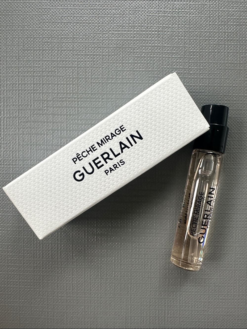 GUERLAIN Pêche Mirage Mini Vial — Clear Glass with Black Cap